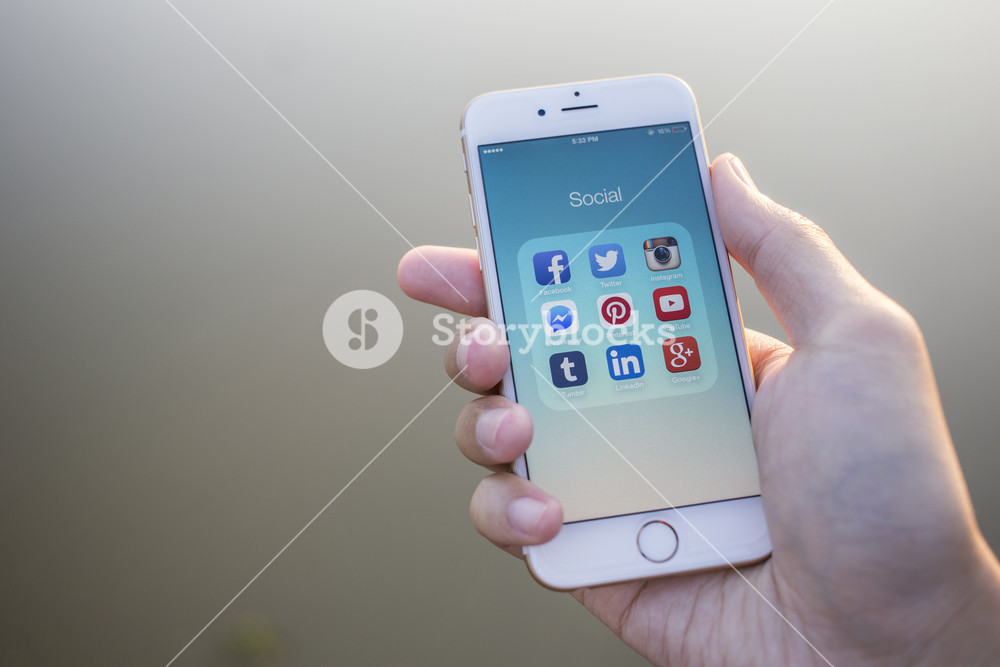 CHIANG MAI, THAILAND - JANUARY 02, 2015: All of popular social media icons on smartphone device screen with hand holding on Apple iPhone 6.