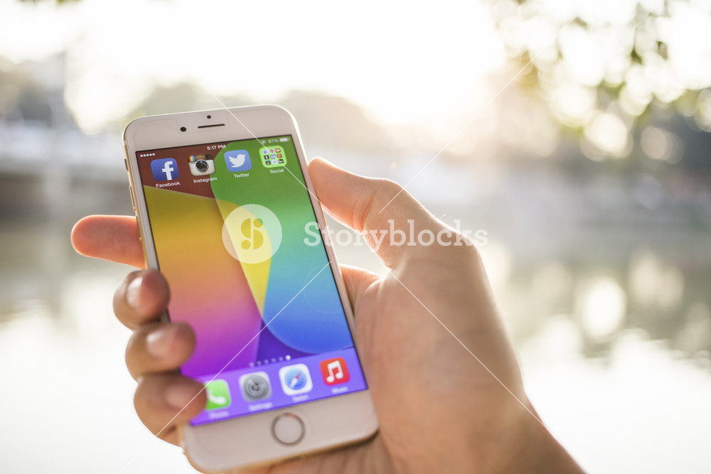 CHIANG MAI, THAILAND - JANUARY 04, 2015: All of popular social media icons on smartphone device screen with hand holding on Apple iPhone 6.