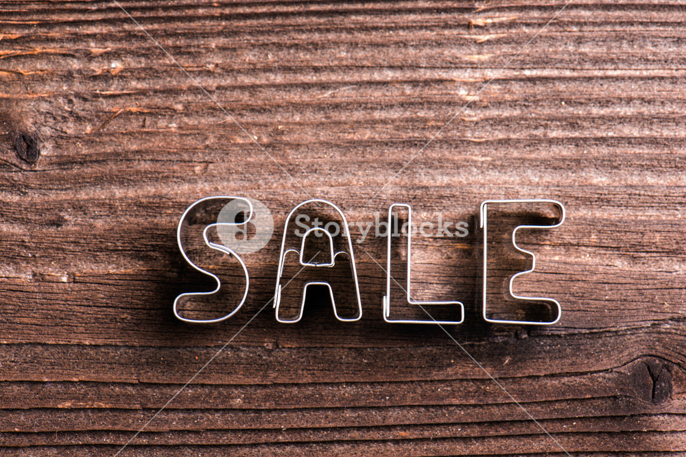 Sale composition. Studio shot on wooden background.