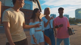 Diverse students walking, sharing stories, laughing, enjoying company. Smart generation. Campus, university, education. Friendship, communication, youth.
