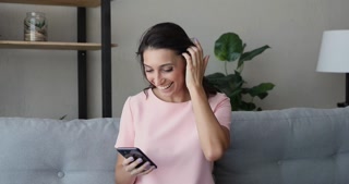 Relaxed young woman receiving positive news notification.