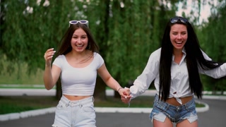 Two friends enjoying a sunny day in the park on a Segway